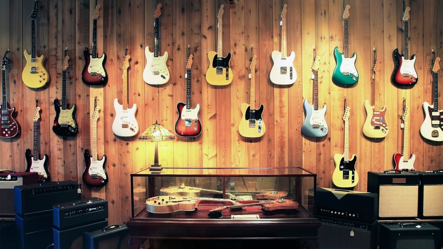 A guitar display featuring Fender guitars